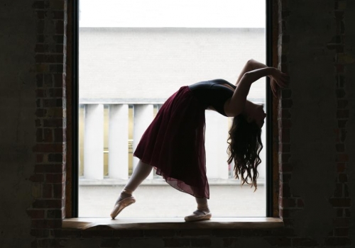 dancer-bends-back-in-window_925x