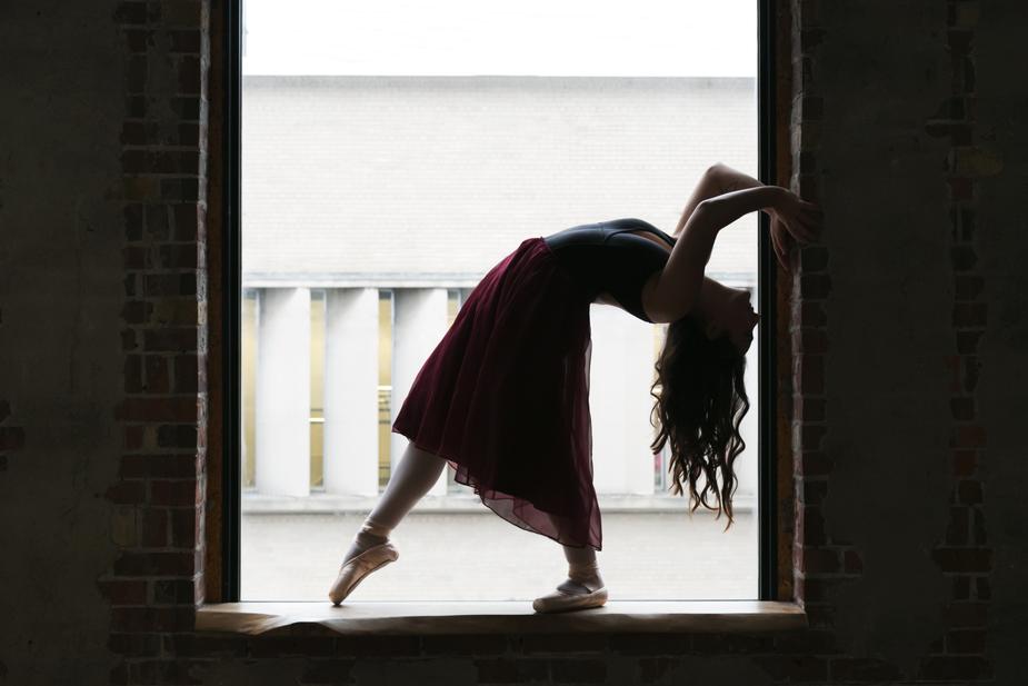 dancer-bends-back-in-window_925x