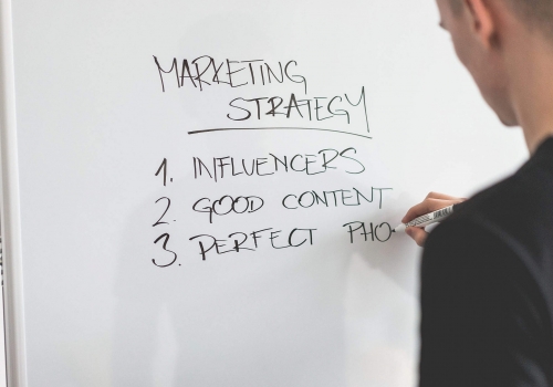 marketing-expert-writing-new-marketing-strategy-on-whiteboard_free_stock_photos_picjumbo_DSC03811-2210x1474