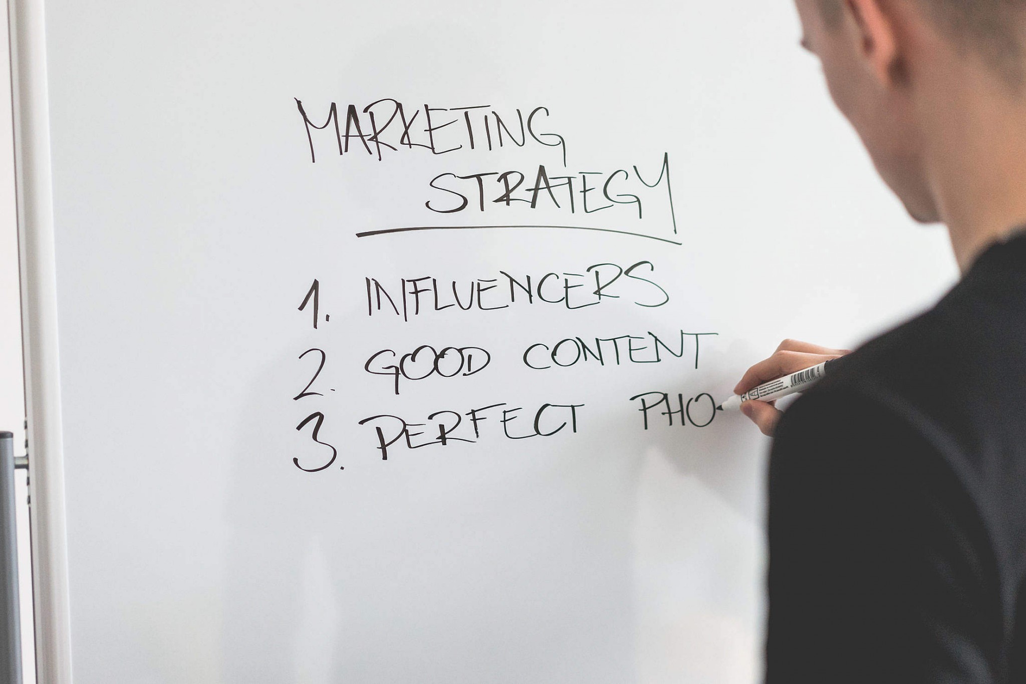 marketing-expert-writing-new-marketing-strategy-on-whiteboard_free_stock_photos_picjumbo_DSC03811-2210x1474