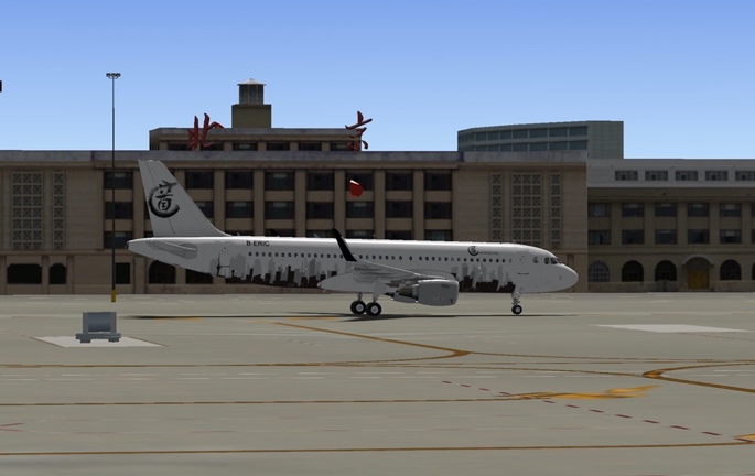 A white airplane on the tarmac
Description automatically generated