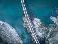 aerial view of bridge on body of water during daytime 白天水体上桥梁的航向观察