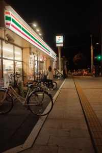 bicycles parked beside the road during night time
