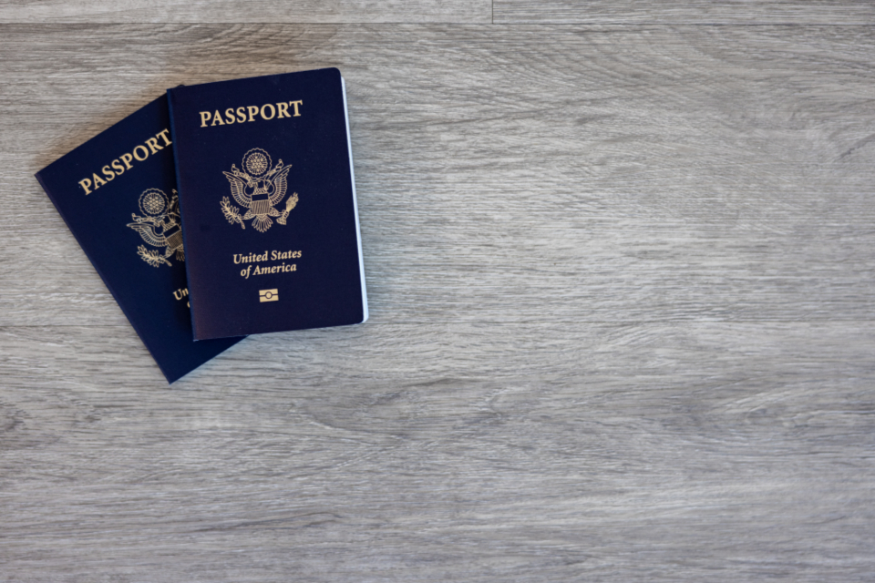 passport table travel close up flat lay wood american document citizen concept identification book desk top view id pair two copy space