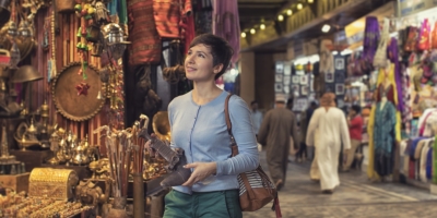 A lady holding a khanjar inside the Muttrah Souq