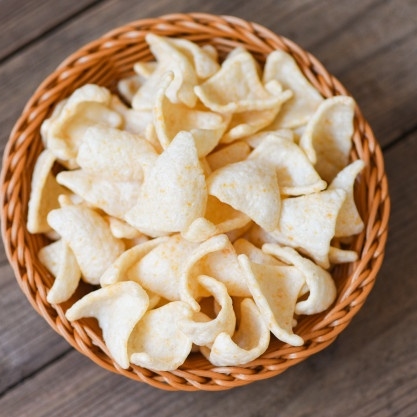prawn-crackers-chips-basket-wooden-table-background_73523-4342