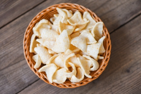 prawn-crackers-chips-basket-wooden-table-background_73523-4342