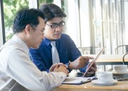 Two,Asian,Businessman,Discussing,Project,In,Office.